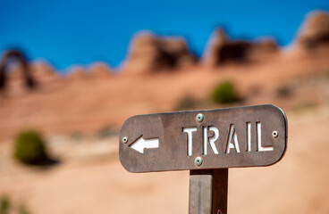 Close up of hiking trail sign in Arches National Park Utah with sandstone formations
