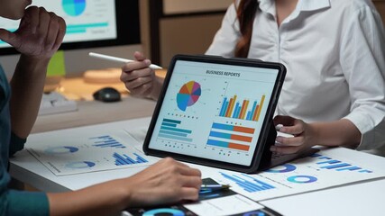 Business colleagues analyzing financial data report in meeting - Powered by Adobe