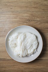 Thai rice noodle in white ceramic plate,thai called Khanom Jeen
