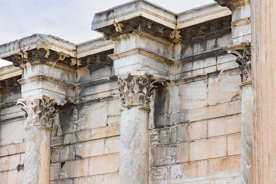 Horizontal full shot of a row of weathered ancient stone columns and a massive wall, highlighting classical architecture detail and texture - Powered by Adobe