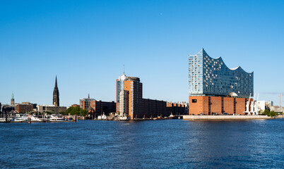 Naklejka premium Elbphilharmonie Hamburg reflects modern architecture. Elbphilharmonie attracts global visitors. Elbphilharmonie Hamburg stands above the Elbe River.