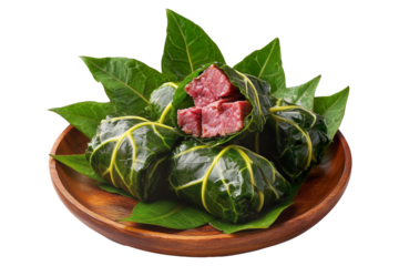 Lu Pulu corned beef cooked in coconut milk in taro leaves in wooden bowl, isolated on white transparent background, concept of traditional Polynesian food
