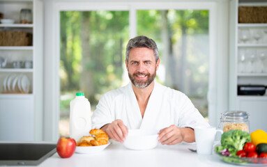 Healthy food concept. Healthy lifestyle. Latin Man with fresh vegetables and fruits for a healthy meal. Man eat fresh salad with organic ingredients. Healthy kitchen.