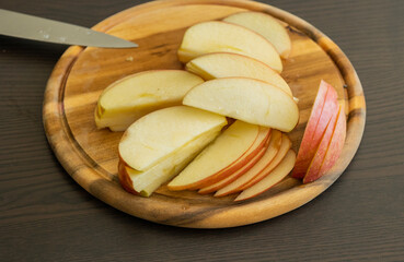 fresh apple slices on wooden cutting board