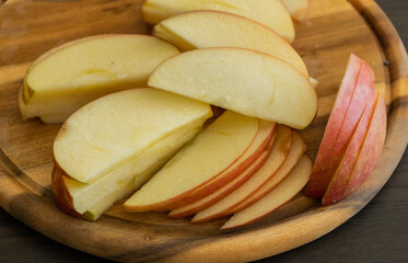 fresh apple slices on wooden cutting board