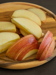 fresh apple slices on wooden cutting board