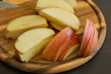 fresh apple slices on wooden cutting board