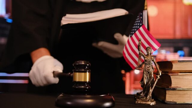 Judge holding document with USA flag and gavel. - Powered by Adobe