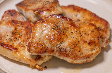 delicious cooked pork chops on white plate