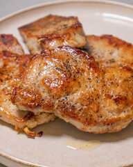 delicious cooked pork chops on white plate