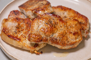 delicious cooked pork chops on white plate