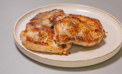 delicious cooked pork chops on white plate