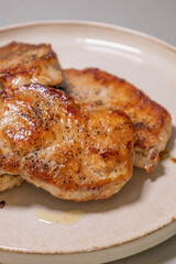 delicious cooked pork chops on white plate