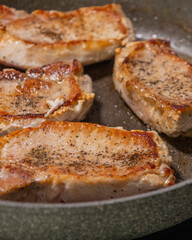 delicious cooked pork chop in a pan on the stove