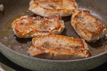 delicious cooked pork chop in a pan on the stove