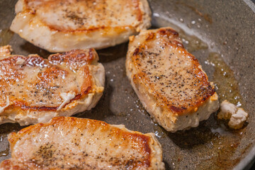 delicious cooked pork chop in a pan on the stove