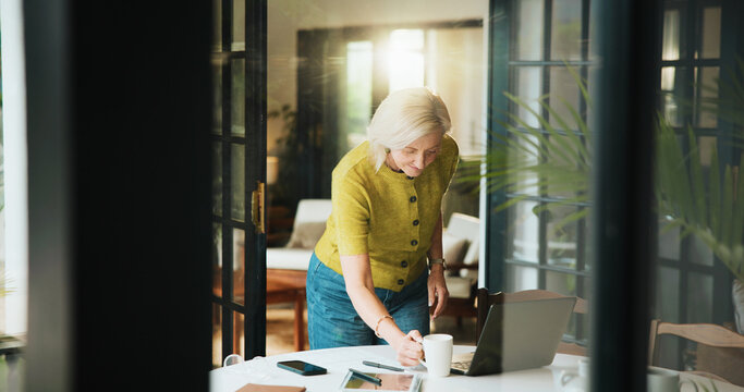 Mature woman, coffee and remote work with laptop in home for morning or creative business. Female person, freelancer or designer with mug, cup or computer for beverage, drink or caffeine in house