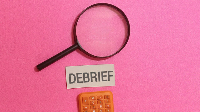 Debrief Concept with Magnifying Glass and Calculator