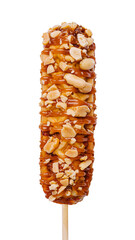 Sweet caramel corn dog coated with crushed peanuts. Delicious Korean-style dessert corn dog on a stick isolated on white background, close-up.