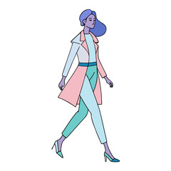 Stylish woman in a pastel coat and trousers walking confidently