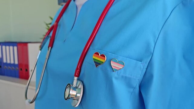 Health professional shows support for LGBTQ community with pride badges and stethoscope