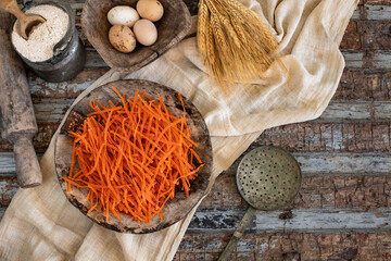 Different types of uncooked pasta on rustic wooden table, in the spoons, cutting board and bowls 