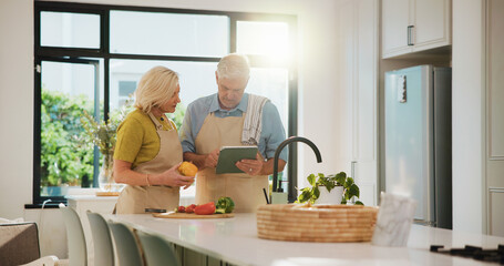 Senior couple, cooking and tablet in kitchen with search, recipe and helping hand for dinner at house. People, vegetables and ingredients with tech, app and tutorial video for nutrition in retirement