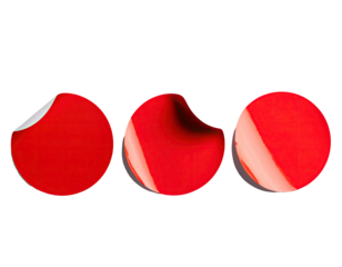 Three red round stickers peeling on black