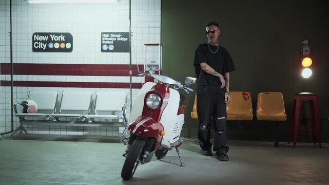 Talented rap artist singing hit in underground decoration in studio, portrait. Filming music video for hip-hop singer, cool guy with tattoos on face and arms, self-expression, contemporary art hobby