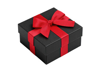 Obraz premium Black box with red ribbon bow against a black background