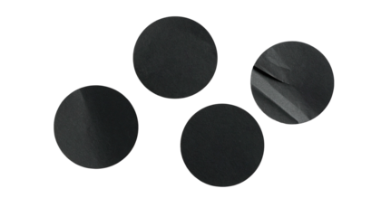 Four dark circles, textured, against a black background