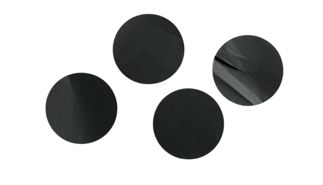 Four dark circles, textured, against a black background
