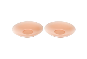 Pair of flesh toned silicone nipple covers for discreet wearing under clothing.