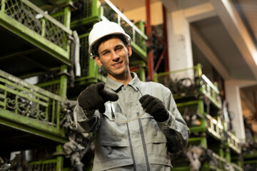 Technician worker working and smile to the camera in garage scrap yard car workshop warehouse.
