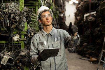 Technician worker working and checking in garage scrap yard car workshop warehouse.
