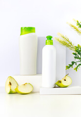 Bio Plastic white bottles with cut apples on thrones Mockup