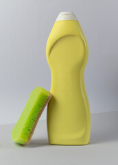 Plastic bottle for detergent with sponge on white background mockup