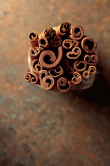 Cinnamon sticks on a rusty background.