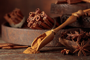 Cinnamon and anise on a brown vintage background.