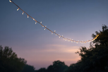 serene evening scene featuring ultrabright white string lights glowing softly against twilight sky