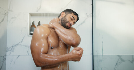 Water, soap and man in shower in bathroom for germs, dirt or bacteria removal with body care....