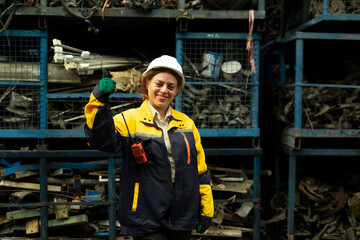 Portrait of technician women worker stand, looking camera happy smiling in garage scrap yard car workshop warehouse.