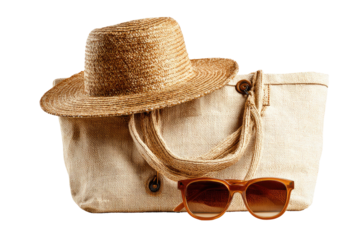 Straw hat on tote bag with sunglasses. Summer getaway