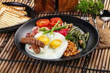 Traditional Engrlish breakfast with egg  and sausages
