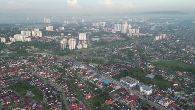 Larkin city with many buildings. The buildings are tall and the sky is cloudy. There are many people in the city