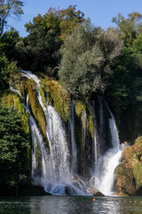 Fototapeta premium Kravitsa Mystical waterfall cascade whispers ancient tales, verdant oasis, tranquil retreat for World Water Day and Forest Bathing rituals