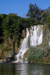 Kravitsa Cascading waterfall dances through lush emerald foliage, embodying tranquility, Earth Day...