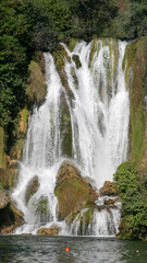 Kravitsa Cascade of crystalline water tumbles over verdant mossy cliffs, echoing nature's symphony; celebrate World Waterfall Day and Ecotourism Week