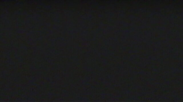 Dark black screen with subtle analog static noise texture, minimalist abstract background overlay, and blank moody space for creative design