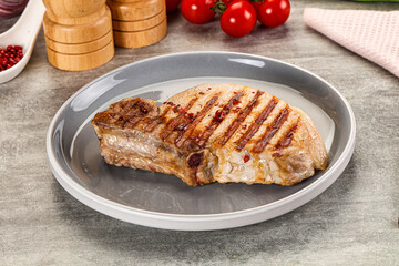 Grilled pork loin steak with bone
